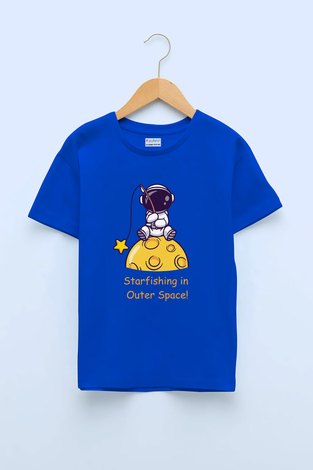 A blue crew neck T-shirt with a print of an astronaut sitting on a moon and the text 'Starfishin' in Outer Space'. The T-shirt is displayed on a hanger against a white background.
