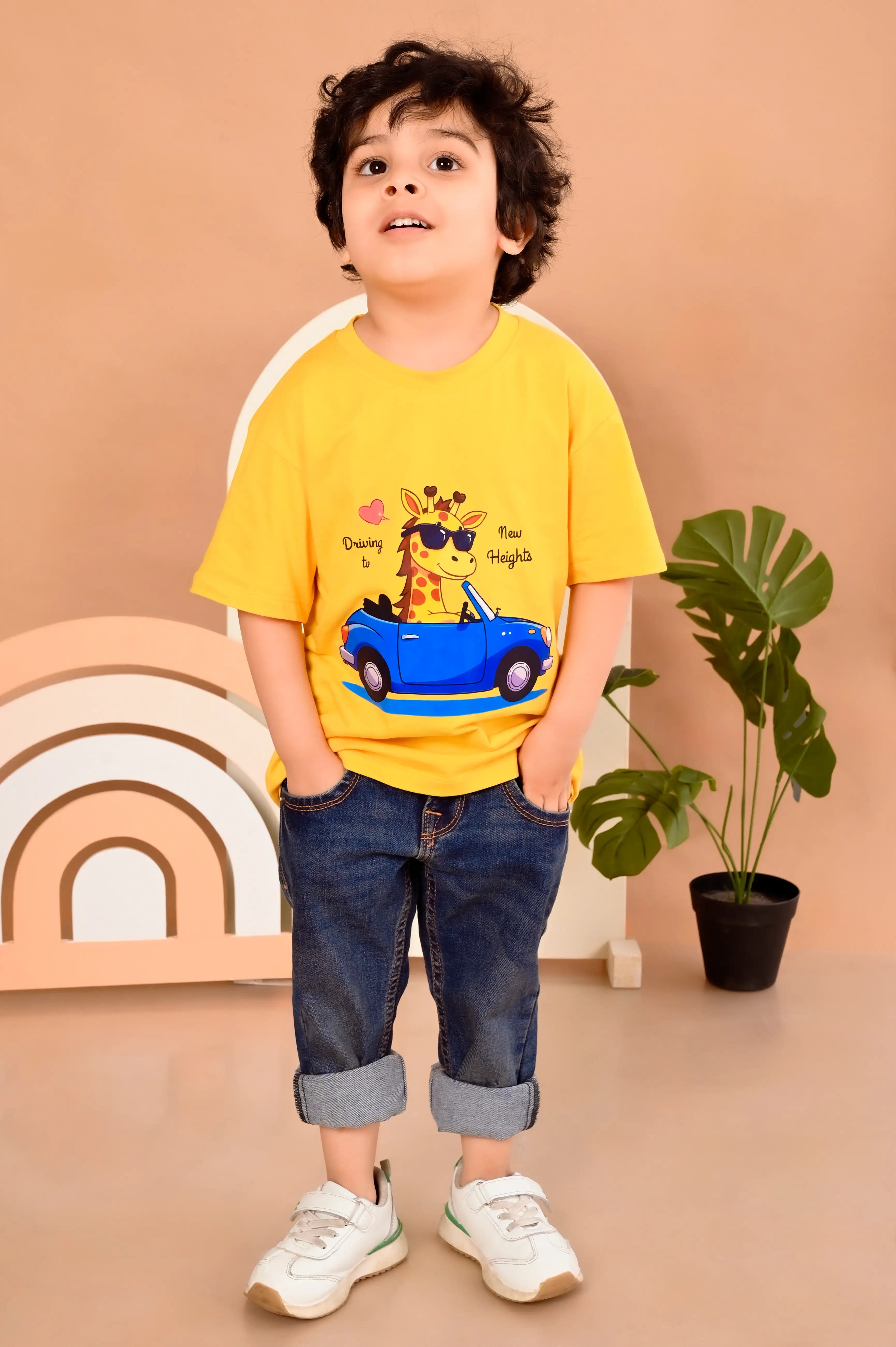 Child wearing a yellow t-shirt with a giraffe driving a car design in 100% cotton material