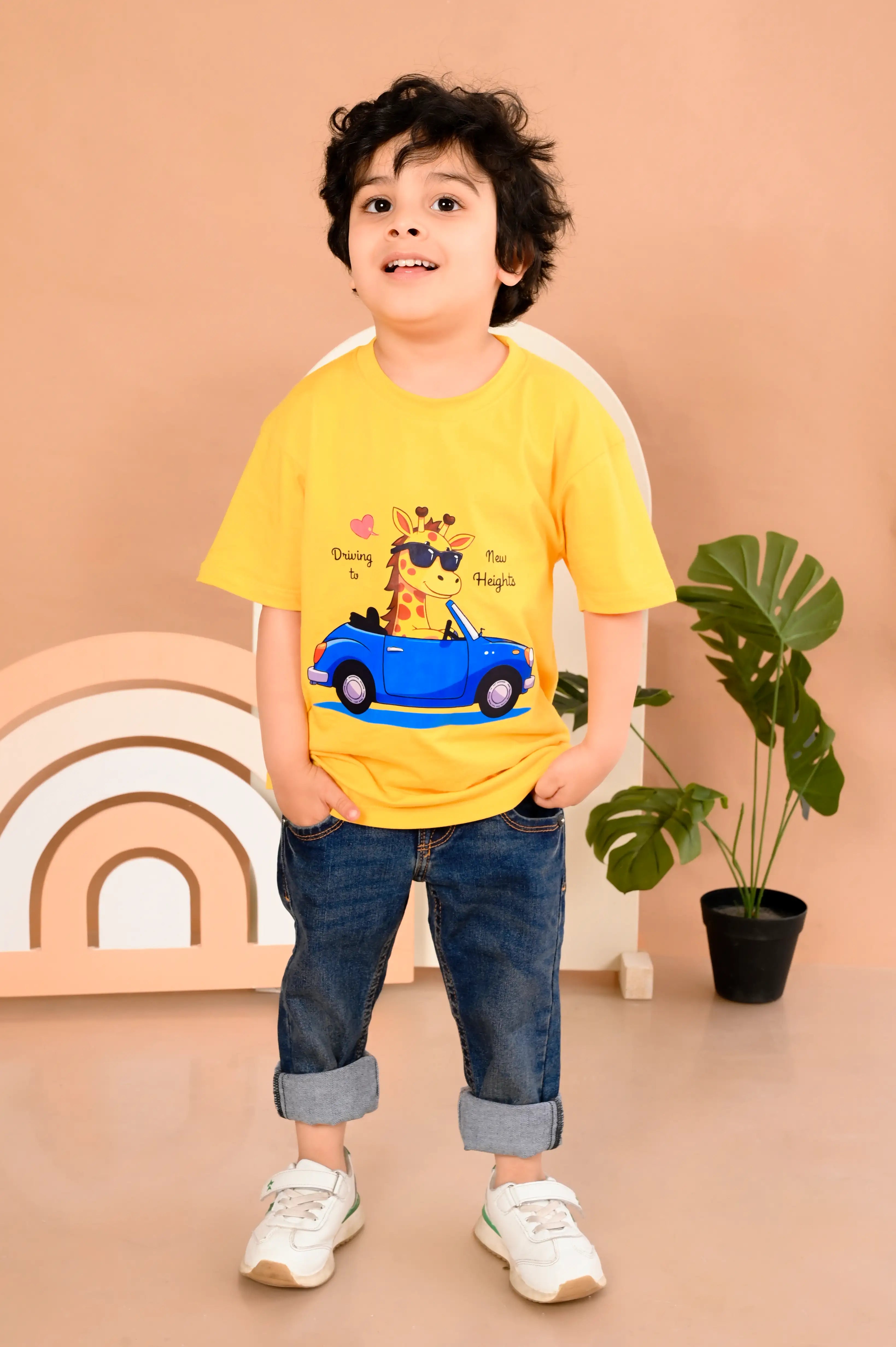 Child wearing a yellow t-shirt with a car and giraffe design in premium cotton material 