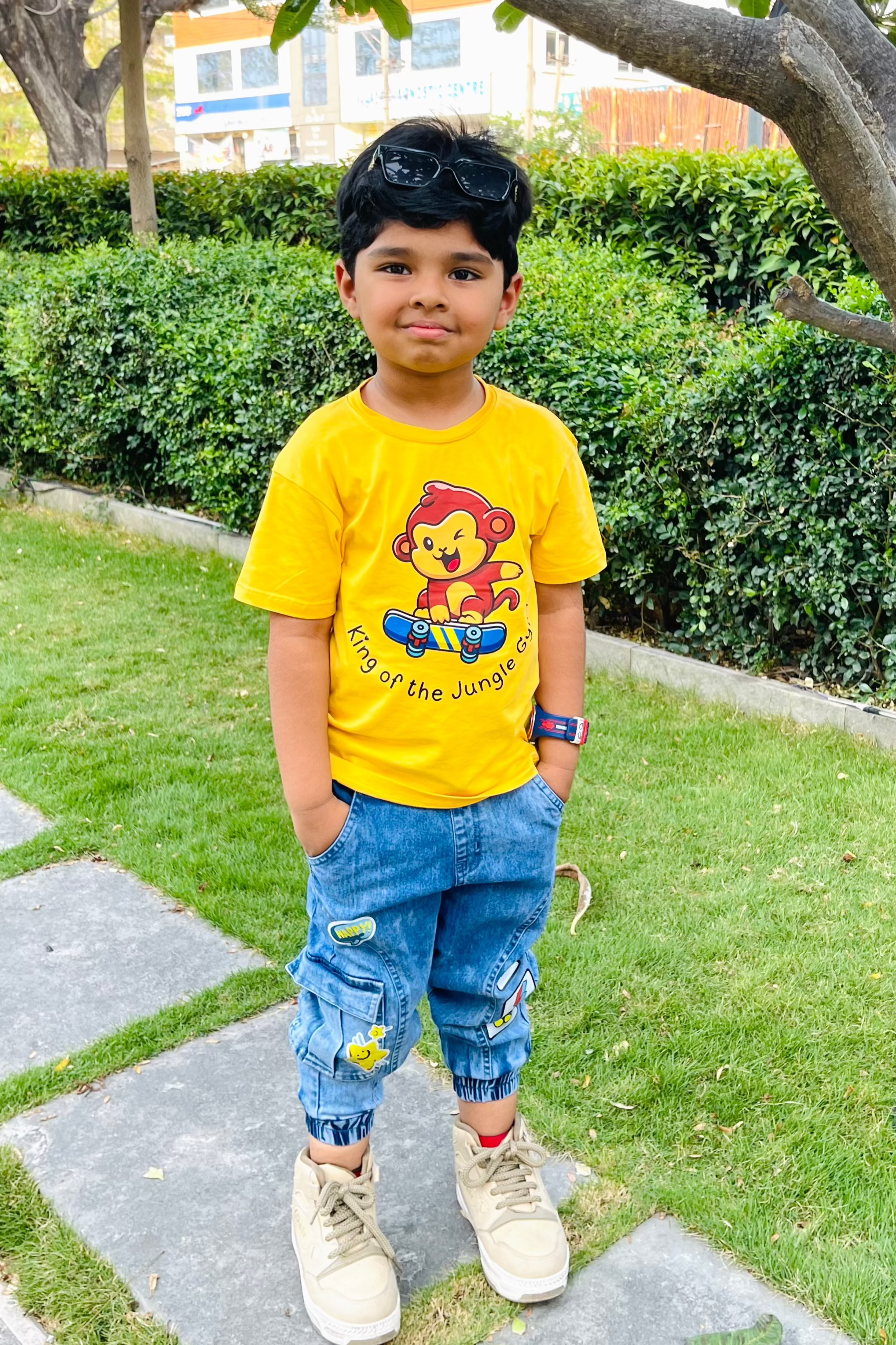 Child wearing a yellow tshirt with monkey on a skateboard design