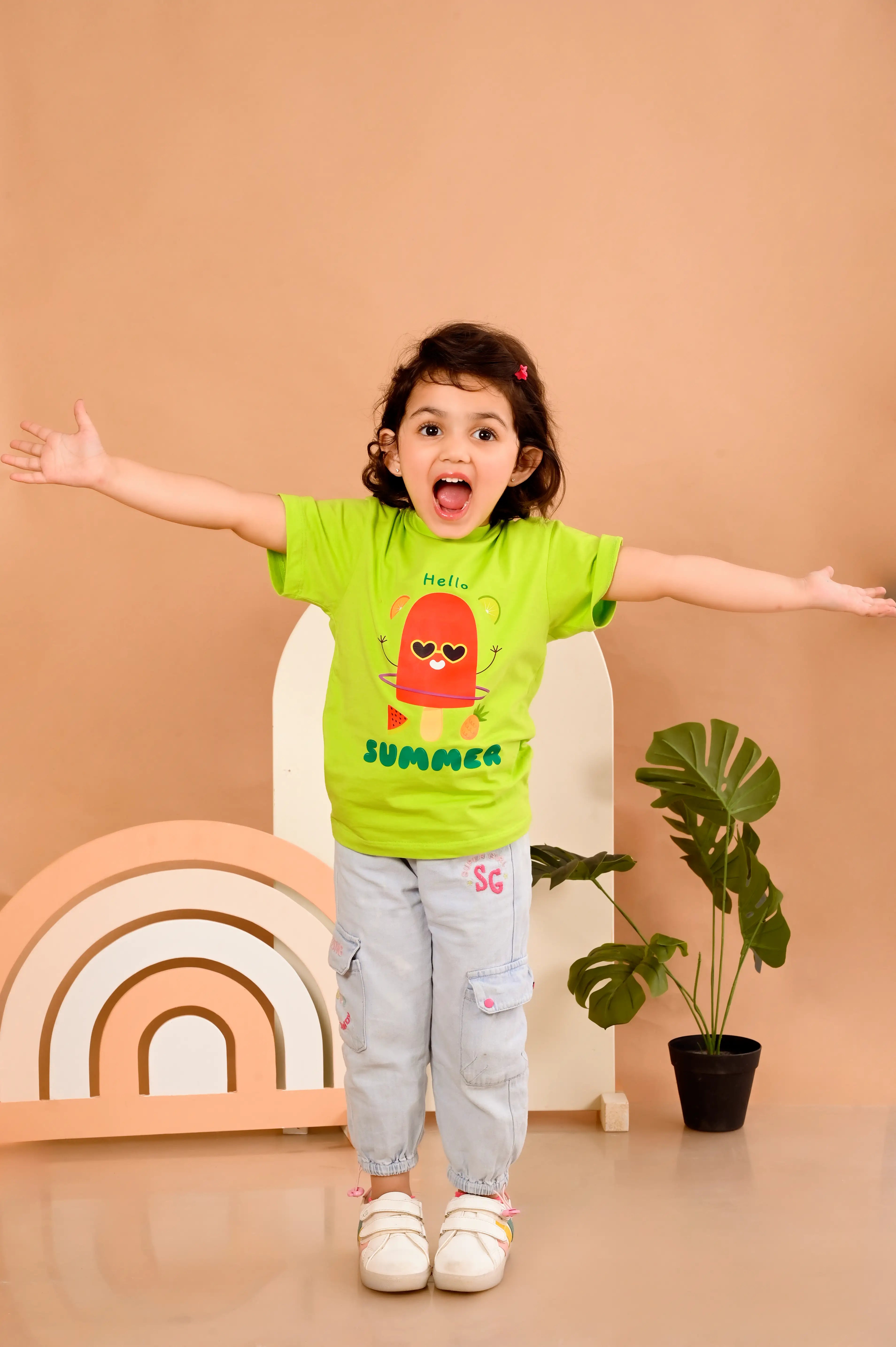 Child wearing a neon green t-shirt with a popsicle and hello summer text