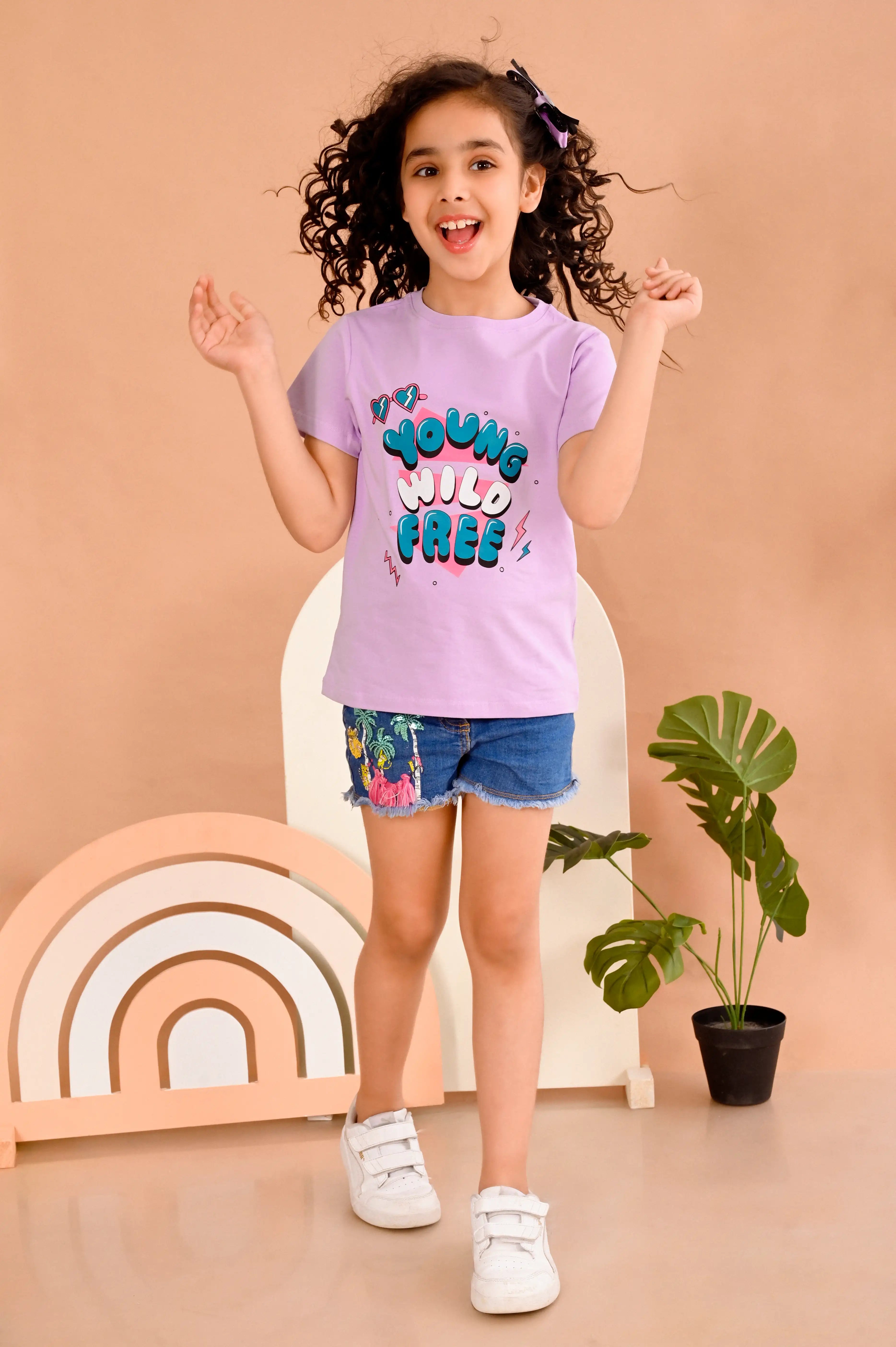 Young girl wearing a lavender t-shirt with colorful young wild free text made out of 100% pure cotton material 