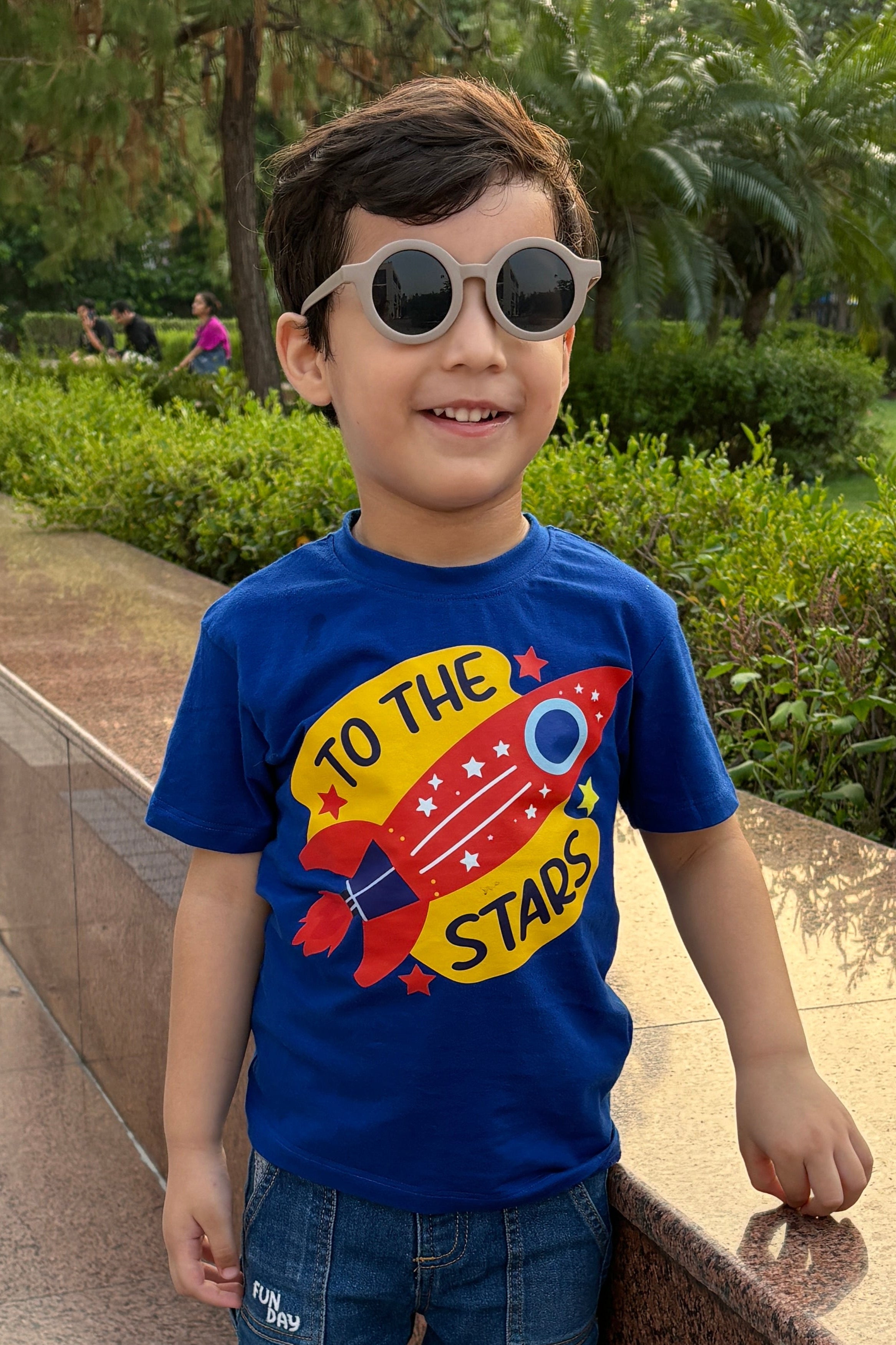 Child wearing Hapyhatch t-shirt in a Royal blue color with a space theme design